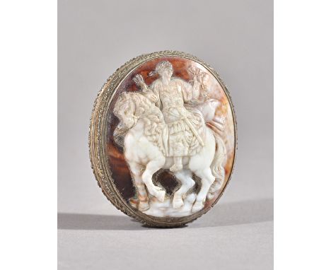 A silver mounted oval shell cameo hinge lidded snuff box, gilt within, the cover with a carved shell cameo depicting the figu