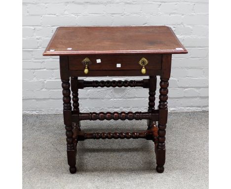 A 17th century oak single drawer side table on bobbin turned supports, 68cm wide x 72cm high. 