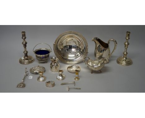 Silver, comprising; a pair of silver table candlesticks (loaded), London 1946, a pair of small candlesticks, a child's pusher