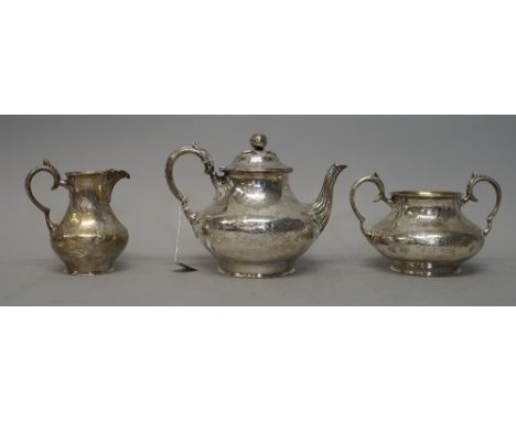 A Victorian silver three piece tea set, comprising; teapot, sugar bowl and milk jug, each piece of baluster form and having e