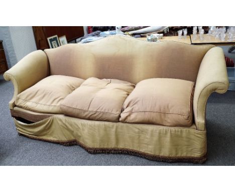 A mahogany sofa, with arched padded back and scrolled arms upon Regency ring-turned ribbed tapering legs and 20th century cas