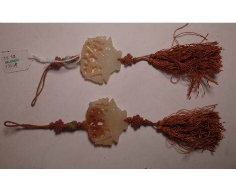 A pair of Chinese jade pendants, each pierced and carved as a basket of flowers, with silk knots and tassels, pendant 5cm. hi