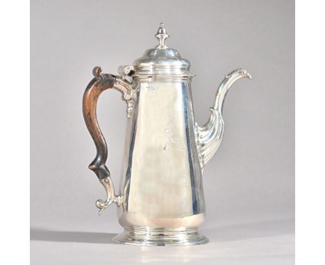 A George II silver coffee pot, of tapered cylindrical form, with an inverted urn shaped finial to the hinged lid, foliate cap