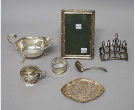 Silver and silver mounted wares, comprising; a shaped oval trinket dish, a sauceboat, a napkin ring, a mustard pot, a sugar s