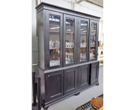 A 19th century French ebonised side cabinet, with four glazed doors over four panel cupboards on bracket feet, 208cm wide x 2