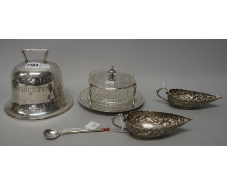 A plated biscuit box, modelled as a bell, detailed Biscuits, a pair of Asian sauceboats, a spoon with a coral hand finial and