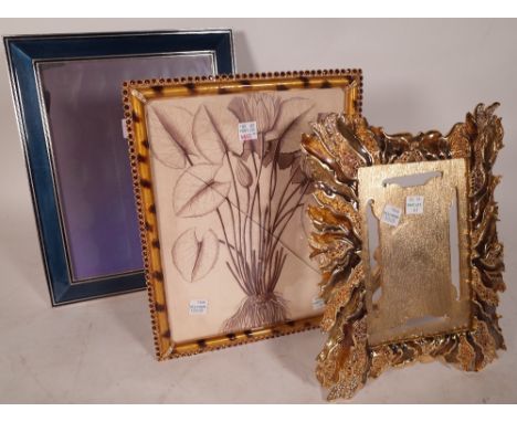 Jay Strongwater; a silvered enamel strutback photograph frame of plain rectangular form, 31cm x 26cm, with cloth bag and two 