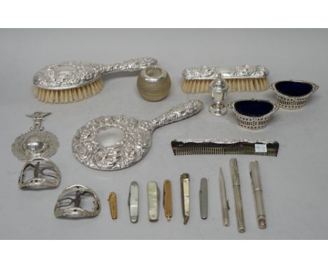 A lady's silver mounted four piece dressing set, comprising; a hairbrush, a hand mirror, a clothes brush and a comb, a silver