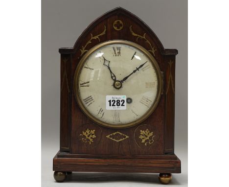 An early 19th century rosewood and brass inlaid mantel clock, with shaped case and brass chain driven fusee movement, 28cm hi
