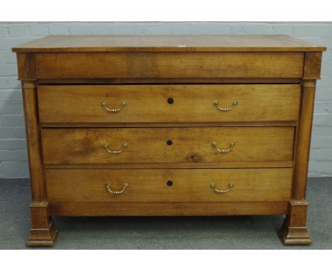 A 19th century fruitwood commode of four long drawers flanked by turned columns, 131cm wide x 93cm high. 