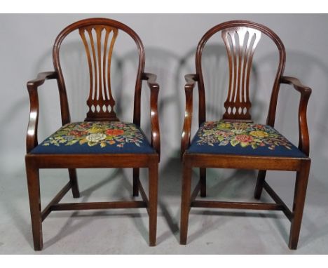 A pair of Hepplewhite design mahogany arch back carver chairs on tapering square supports, 56cm wide x 96cm high. 