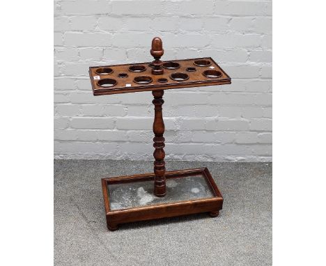 A Victorian stained beech umbrella stand, on ring turned baluster support and rectangular base, zinc liner and bun feet 52.5c