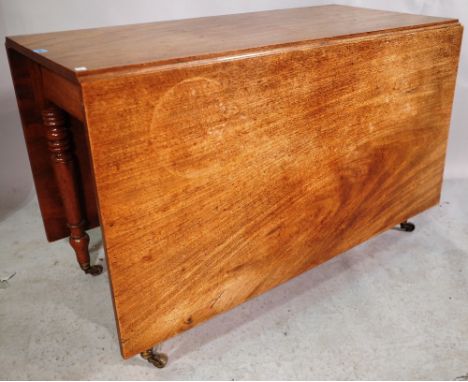 An early Victorian mahogany drop flap dining table on ring turned tapering supports 179cm long x 114cm wide x 72cm high. 