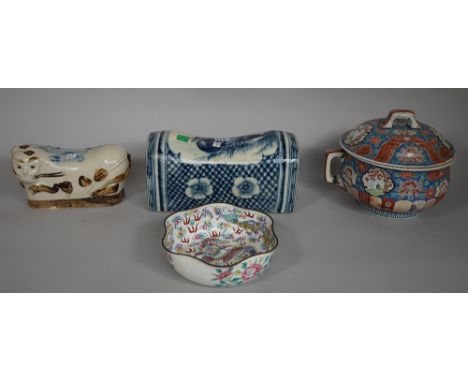 A Chinese blue and white pottery pillow decorated with a duck, 31.5cm wide, another modelled as a cat, a Chinese famille rose