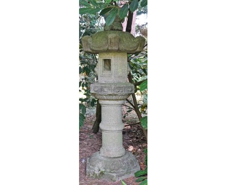 A Japanese carved stone garden lantern, 19th/20th century, on pedestal, 183cms high.