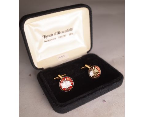 A pair of gold plated and enamel 1932 three piece cufflinks. 