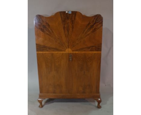 A mid-20th century walnut arch top side cabinet, with specimen wood veneered sunburst front on cabriole supports, 80cm wide x