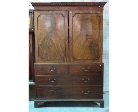 A George III mahogany linen press, the pair of panelled doors over two short and two long graduated drawers on bracket feet, 