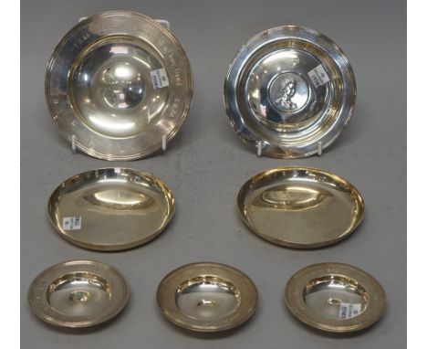 Silver, comprising; a pair of circular plain dishes, London 1963, a circular dish, the centre inset with a coin with an Eliza