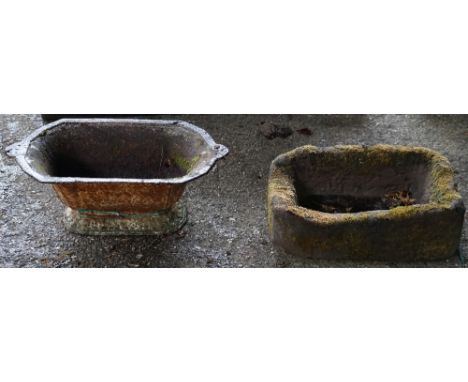 A 20th century wrought iron balustrade panel, 188cm wide, a small carved stone trough and a 19th century cast iron planter. (