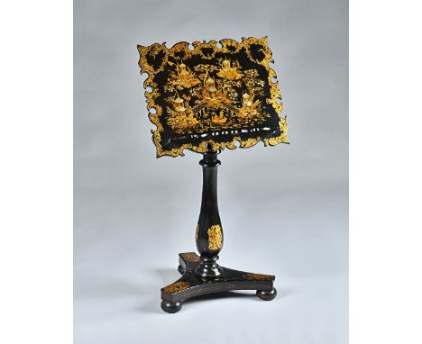 A Victorian black and gilt decorated music stand in the manner of Jennens and Bettridge, the shaped oblong top with mother-of