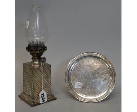 A late Victorian silver cased oil lamp base, maker's mark rubbed, Birmingham 1890, 8.5cms wide, 28cms high including glass sh