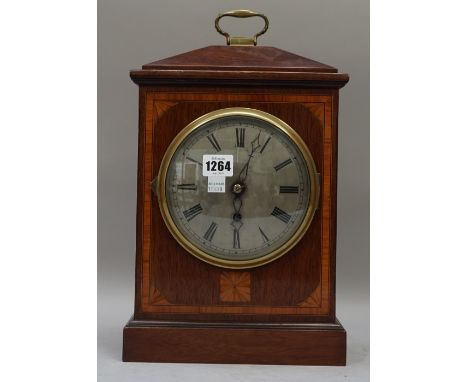 A mahogany and inlaid mantel clock with a six inch silvered dial and single train fusee movement, 34cm high. 