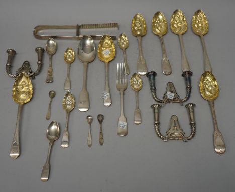 Assorted silver flatware including; a George III pair of asparagus tongs, various parcel-gilt berry spoons, various plain spo