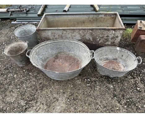 A metal trough, two oval galvanised metal tubs and two galvanised metal buckets (5)Please note:You are reminded under our Ter