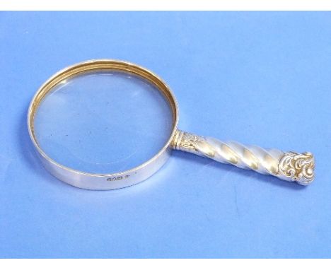 A late Victorian silver mounted Magnifying Glass, by William Comyns, hallmarked London, 1899, of circular form, the handle fl