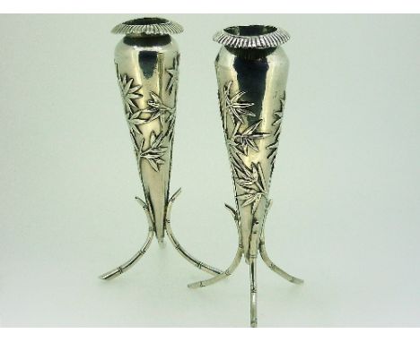 A pair of Oriental silver Specimen Vases, unmarked but tested as silver, of tapering circular form, chased with bamboo decora