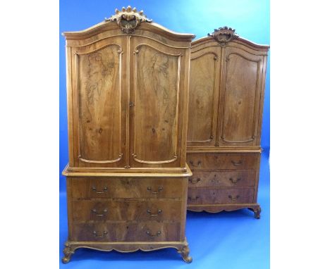 A pair of late 19thC continental walnut Linen Presses, of arched form, each with a carved crest and moulded cornice over a pa