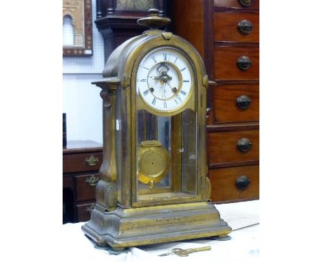 A French gilt metal four-glass Mantel Clock, of arched form with 8-day movement striking on a bell, the two-piece enamel dial