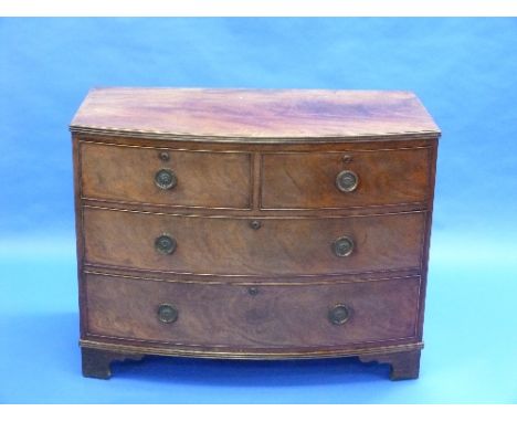 A George III mahogany bow front Chest, the shaped top with reeded edge above two short and two long graduated drawers with br