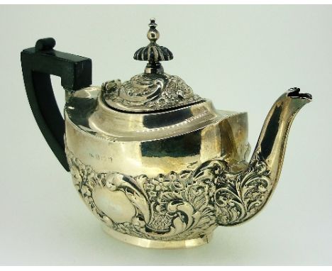 An Edwardian silver Teapot, by Marks & Cohen, hallmarked Birmingham, 1906, with floral and foliate repousse decoration, eboni