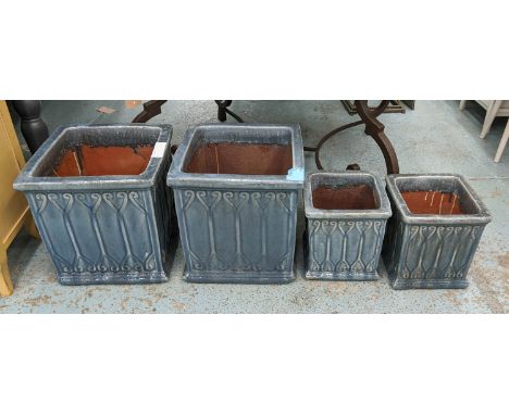 PLANTERS, two graduated pairs, blue glazed ceramic, 42cm x 41cm x 43cm at largest. (4) 