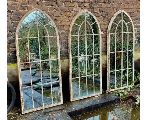 ARCHITECTURAL GARDEN WALL MIRRORS, a set of three, aged metal frames, 160cm x 67cm. (3) 