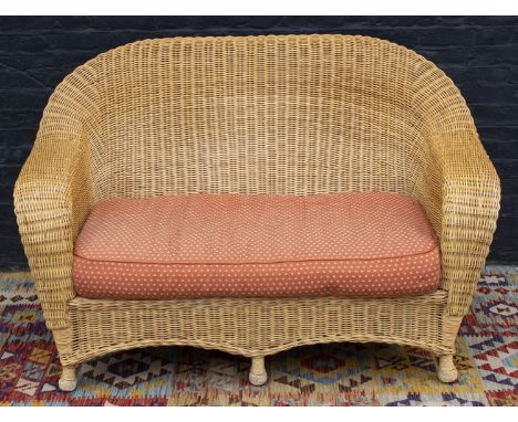 RATTAN CONSERVATORY SETTEE, 20th century, with faded red cushion seat, 147cm W. 