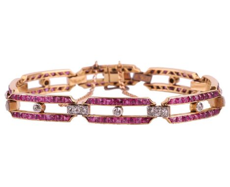 A ruby and diamond bar link bracelet, comprising eight hinged bars set with calibre cut rubies and old cut diamonds, each bar