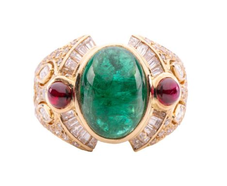 An emerald, ruby and diamond dress ring, centred with an oval emerald cabochon approximately measures 11.8 x 8.9 x 5.9 mm, fl