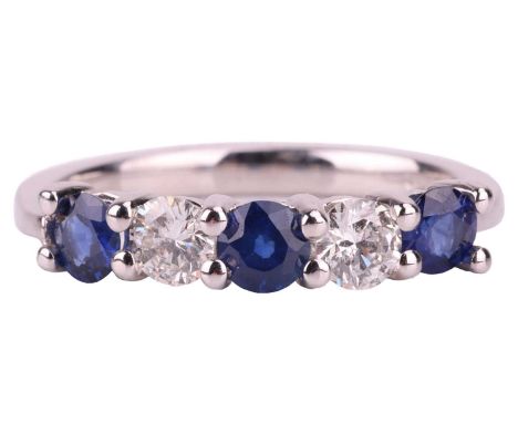 A sapphire and diamond five-stone ring in 18ct white gold, containing three circular-cut sapphires of 3.8 mm flanking two bri