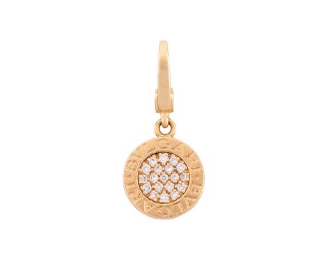 Bulgari - a diamond-set charm, circular plaque edged with engraved legend, pavé-set with nineteen diamonds at the centre, wit