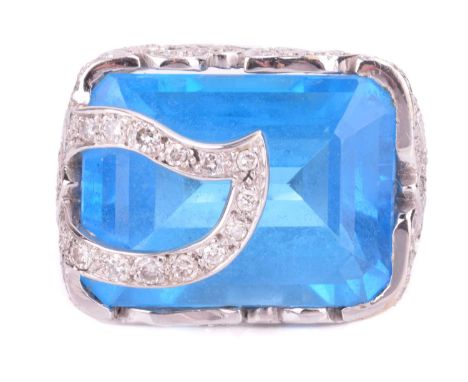 A blue topaz and diamond cocktail ring, containing a large Swiss blue topaz approximately measures 20.2 x 15.0 x 9.8 mm, to a