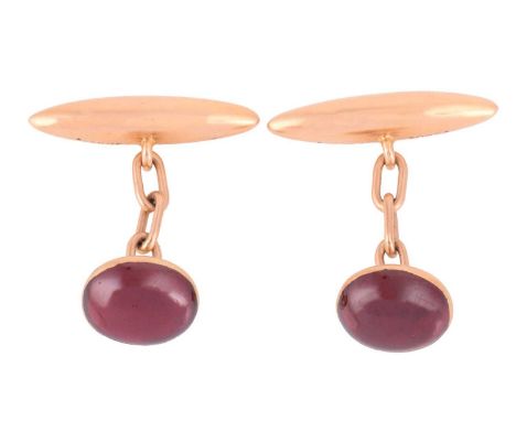 A pair of garnet cabochon cufflinks, comprising oval garnet cabochons in collet settings, connected to torpedo toggles with c