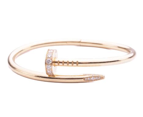 Cartier - a 'Juste un Clou' diamond-set bracelet in 18ct yellow gold, classic model, of a hinged bent nail motif, signed and 