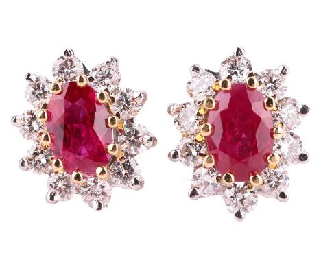 A pair of ruby and diamond cluster earrings, set in 18ct bi-colour gold, the central oval rubies of deep pinkish-red colour, 