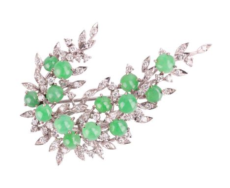 A jade and diamond spray brooch, designed as a spray of foliage with fourteen round jade cabochons interspersed in a diamond 