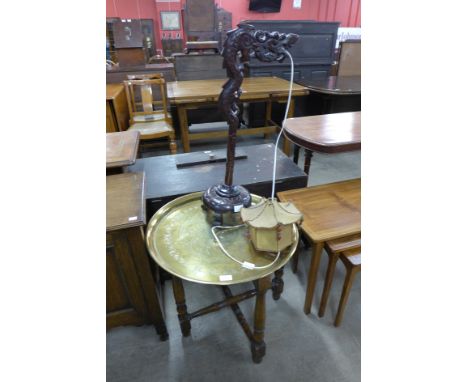 A Chinese hardwood dragon table lamp and an eastern brass topped table