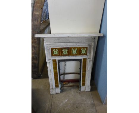A Victorian cast iron and tile back fire insert