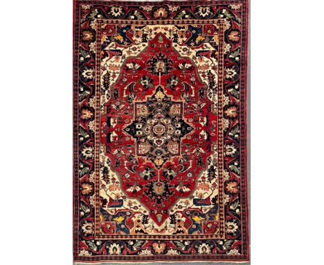 A early 20th century Persian Islamic Ardebil Heriz cork wool floor carpet rug. The rug having central graduating medallions i